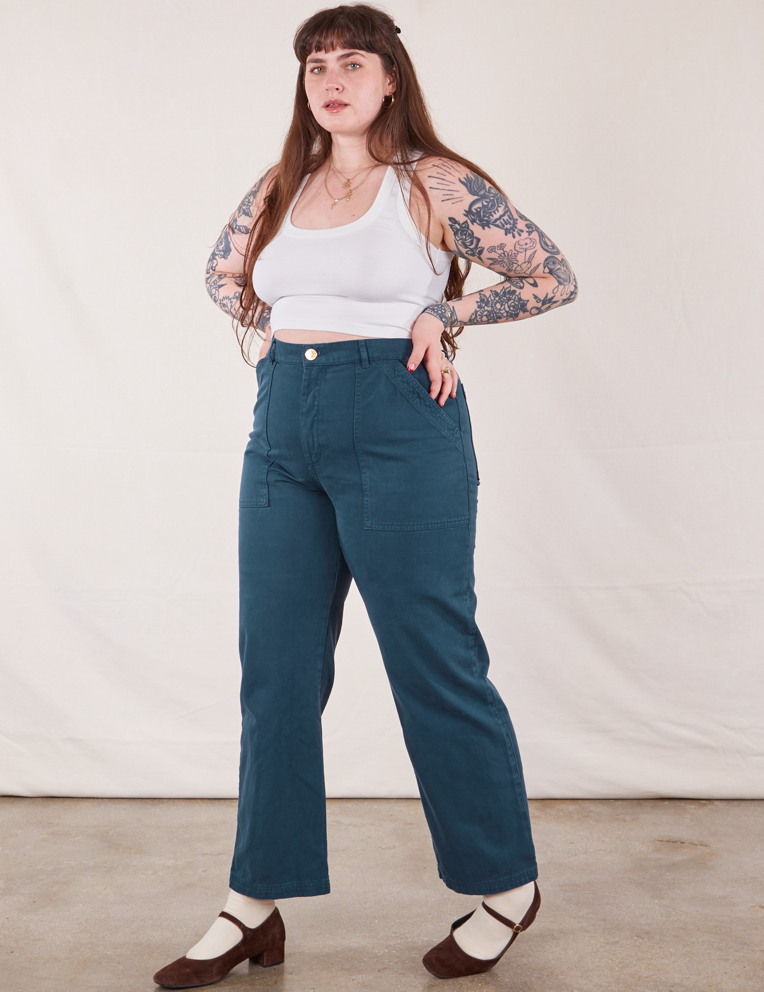 Angled front view of Work Pants in Lagoon and vintage tee off-white Cropped Tank on Sydney