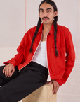 Anthony is wearing Mechanic Jacket in Mustang Red and black Western Pants