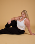 Baggy Mid-Rise Trousers in Basic Black and vintage tee white Cropped Tank worn by Juliet