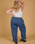 Back view of Baggy Mid-Rise Trousers in French Blue and vintage tee white Cropped Tank on Juliet