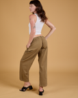 Angled back view of Baggy Mid-Rise Trousers in Desert Brown and vintage tee white Cropped Tank on Alex