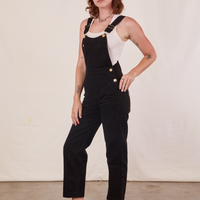 Angled view of Original Overalls in Mono Black and vintage off-white Cropped Tank Top worn by Alex