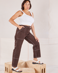 Side view of Railroad Carpenter Jeans in Fudgesicle Brown and vintage tee off-white Square Neck Tank worn by Tiara