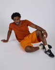 Longline Work Shorts in Creamsicle Orange and burnt terracotta Organic Vintage Tee worn by Isaac