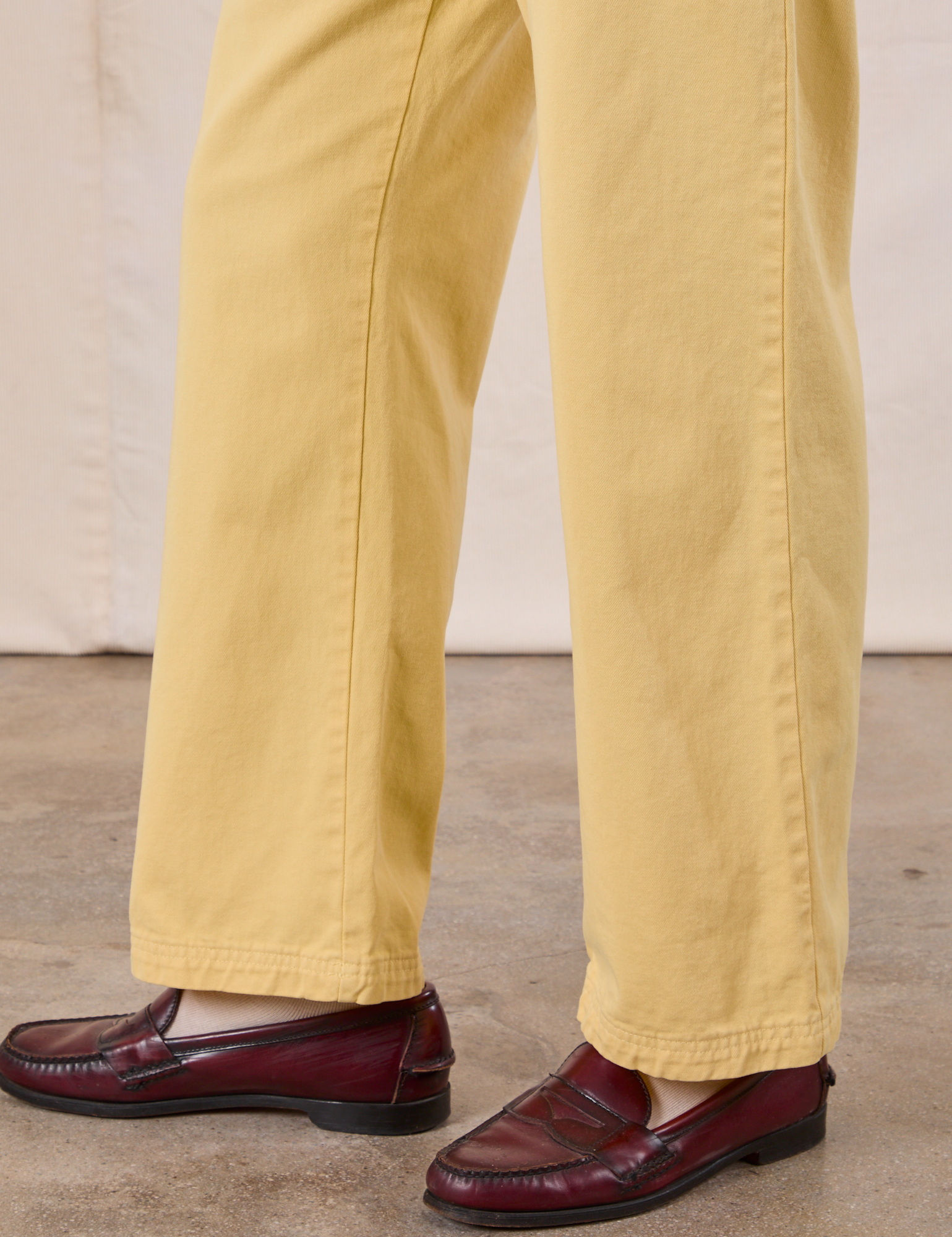 Work Pants in Butter Yellow side view pant leg close up on Anthony