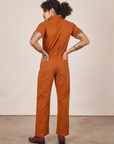 Back view of Short Sleeve Jumpsuit in Burnt Terracotta worn by Jesse