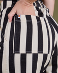 Close up of Alex's hand in the back pocket of Longline Work Shorts in Natural