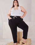 Marielena is 5'8" and wearing 1XL Rolled Cuff Sweat Pants in Basic Black paired with Cropped Tank in vintage tee off-white 