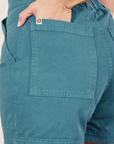 Classic Work Shorts in Marine Blue back pocket close up. Tiara has her hand in the pocket.