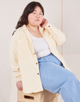 Ashley is wearing Corduroy Overshirt in Vintage Off-White and light wash Denim Trousers