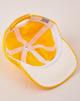 Dugout Corduroy Hat in Sunshine Yellow flipped over. White satin under-bill.