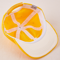 Dugout Corduroy Hat in Sunshine Yellow flipped over. White satin under-bill.