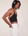 Side view of Halter Top in Basic Black and vintage off-white Western Pants worn by Jerrod