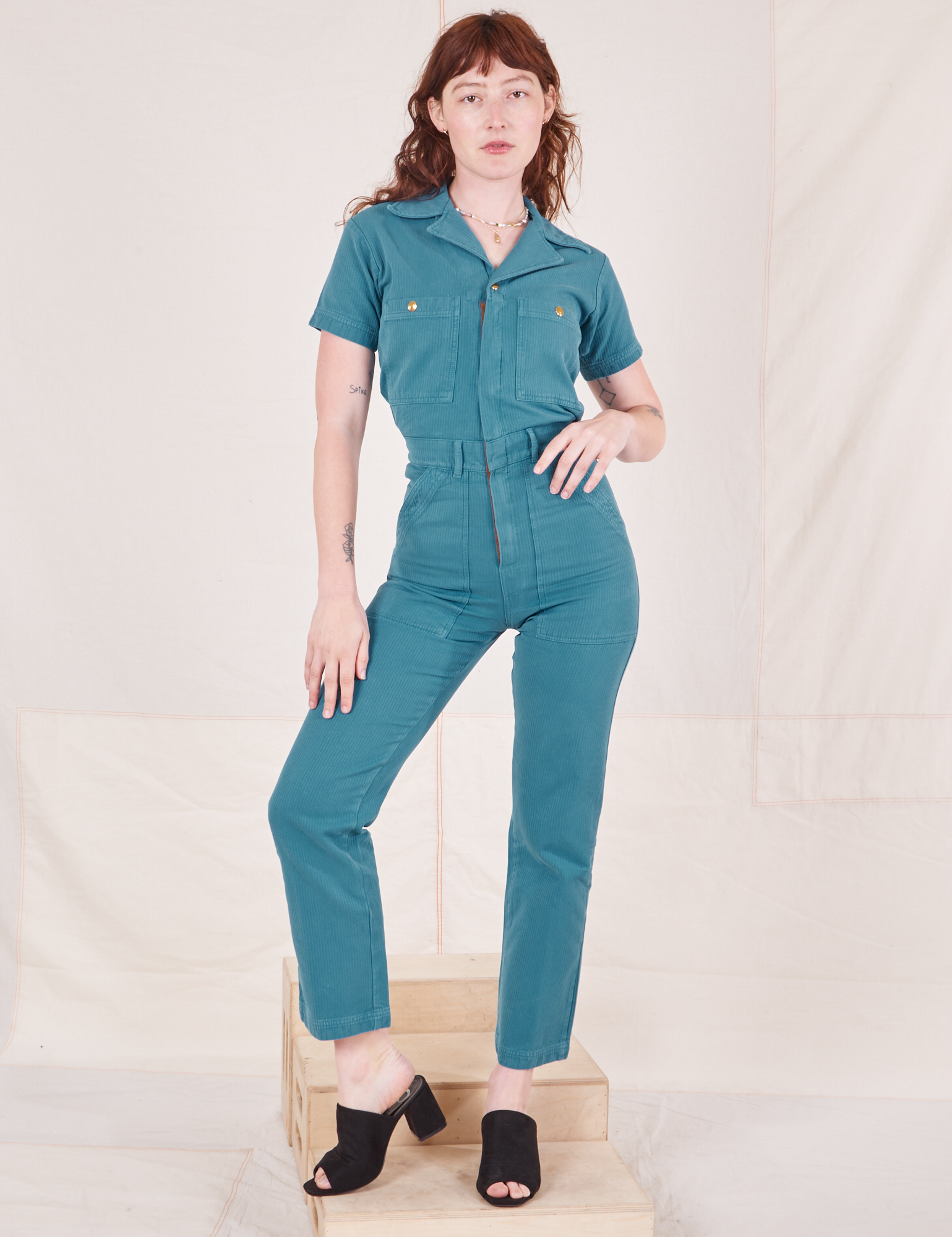Alex is 5&#39;8&quot; and wearing size XS Heritage Short Sleeve Jumpsuit in Marine Blue