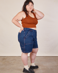 Side view of Carpenter Shorts in Dark Wash and burnt terracotta Cropped Tank on Ashley