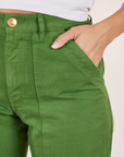 Pencil Pants in Lawn Green font pocket close up. Tiara has her hand in the pocket.