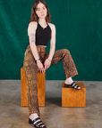 Hana is wearing Leopard Work Pants and black Halter Top