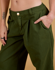 Close up of Alex's hand in the front pocket of Baggy Mid-Rise Trousers in Evergreen