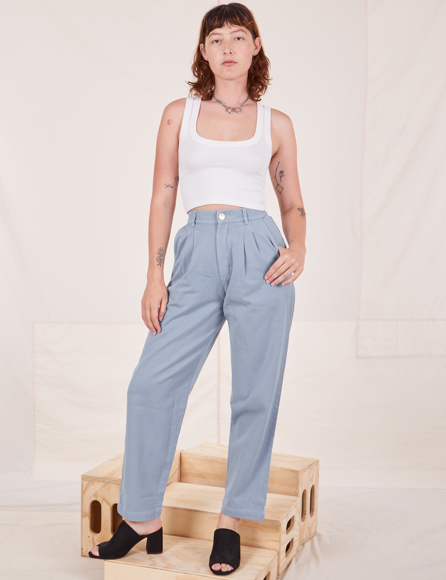 Alex is wearing Organic Trousers in Periwinkle and Cropped Tank Top in vintage tee off-white