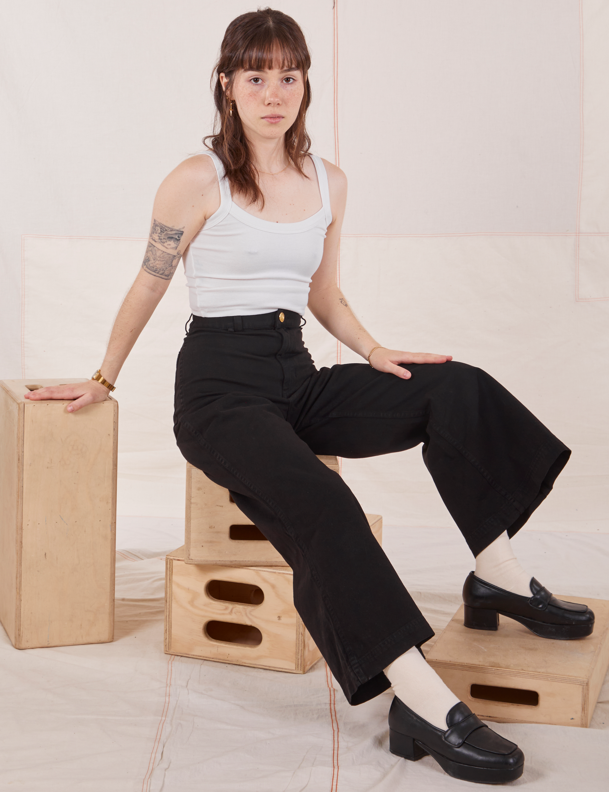 Hana is wearing Petite Bell Bottoms in Basic Black and Cropped Cami in vintage off-white
