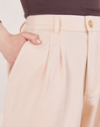Heritage Trousers in Vintage Off-White front close up. Hana has her hand in the pocket.