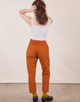 Back view of Petite Pencil Pants in Burnt Terracotta and Cropped Cami in vintage tee off-white on Hana