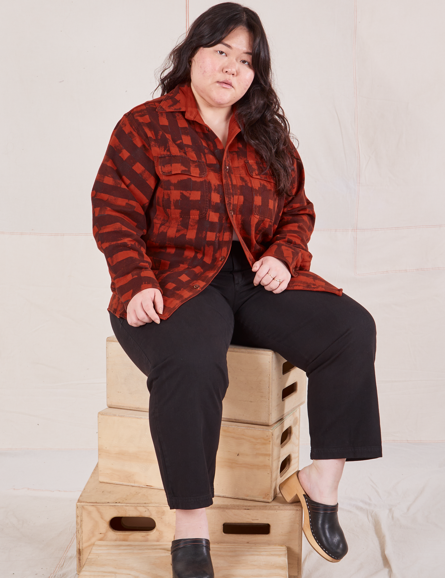 Ashley is wearing Plaid Flannel Overshirt in Paprika and black Work Pants