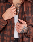 Plaid Flannel Overshirt in Fudgesicle Brown front close up on Jesse