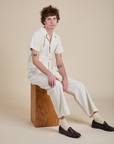 Quinn is wearing Short Sleeve Jumpsuit in Vintage Tee White