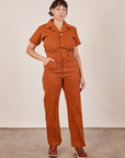Tiara is 5'4" and wearing S Short Sleeve Jumpsuit in Burnt Terracotta