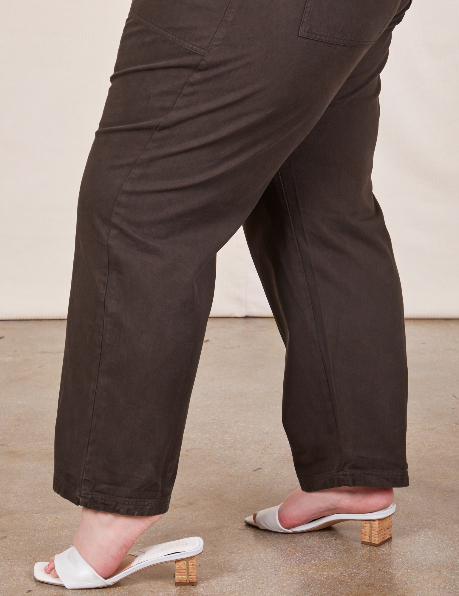 Side pant leg close up of Short Sleeve Jumpsuit in Espresso Brown worn by Marielena