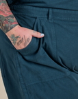 Close up of Sam's hand in the front pocket of Short Sleeve Jumpsuit in Lagoon
