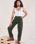 Jesse is 5'8" and wearing XS Heritage Trousers in Swamp Green paired with Cropped Tank Top in vintage off-white