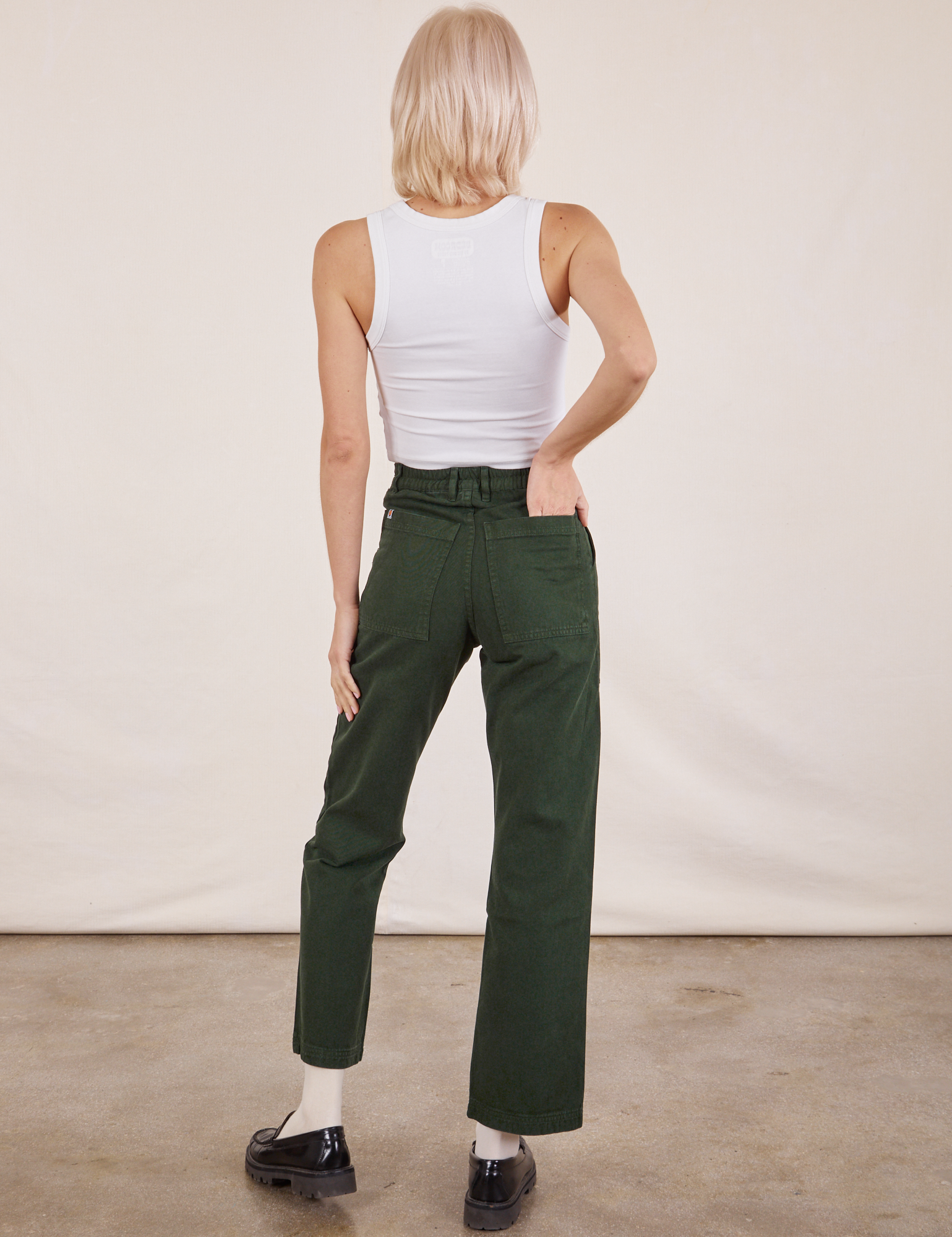 Back view of Work Pants in Swamp Green and vintage tee off-white Cropped Tank on Madeline