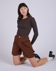 Pleated Trouser Shorts in Fudgesicle Brown and Long Sleeve Baby Tee in Espresso Brown worn by Alex