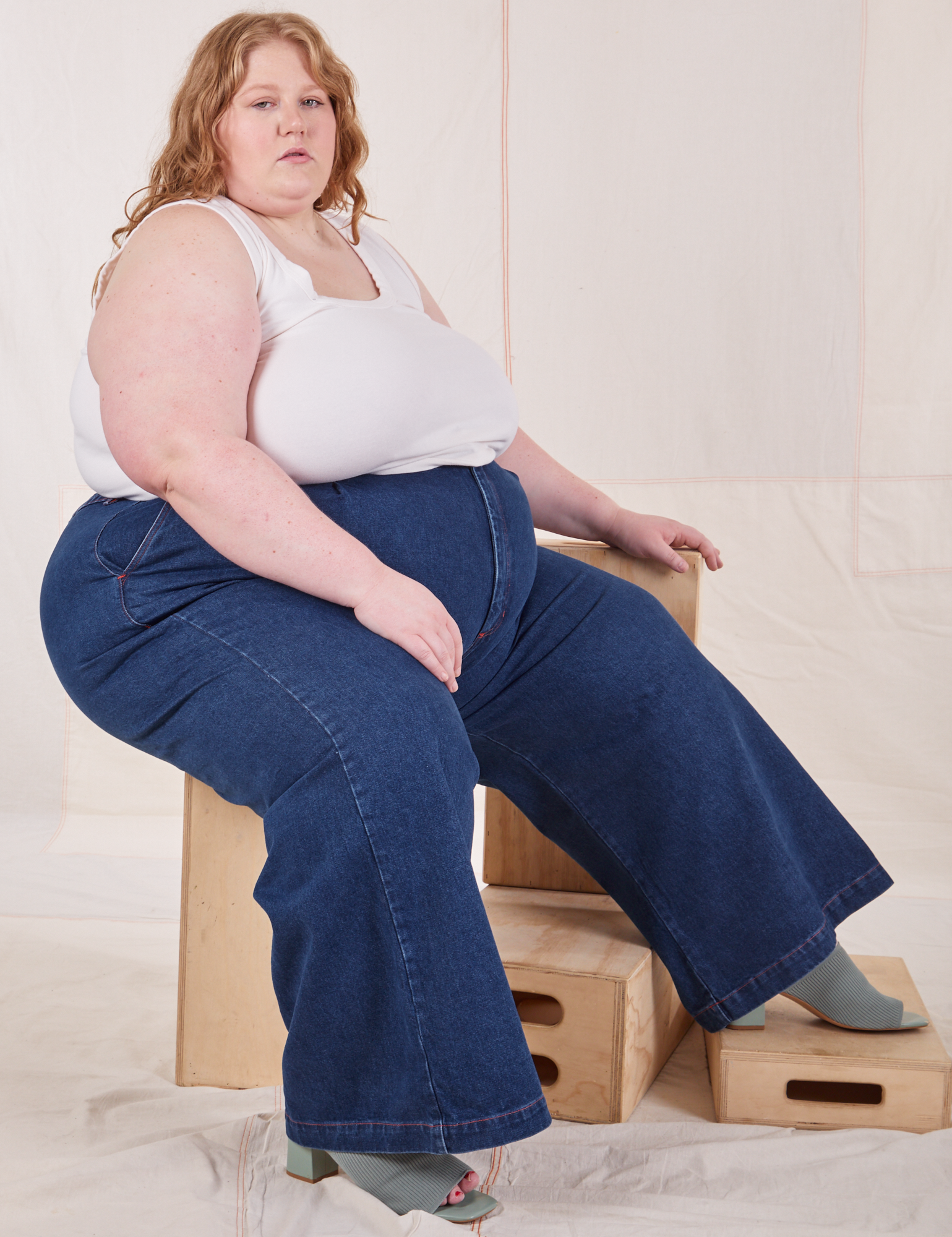 Catie is wearing Indigo Wide Leg Trousers in Dark Wash and vintage off-white Cropped Tank Top.