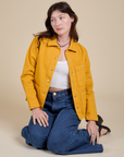 Alex is wearing Denim Work Jacket in Mustard Yellow