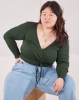 Ashley is wearing Wrap Top in Swamp Green and light wash Carpenter Jeans