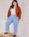 Ashley is 5'7" and wearing L Cropped Zip Hoodie in Burnt Terracotta paired with a vintage off-white Cropped Tank and light wash Carpenter Jeans