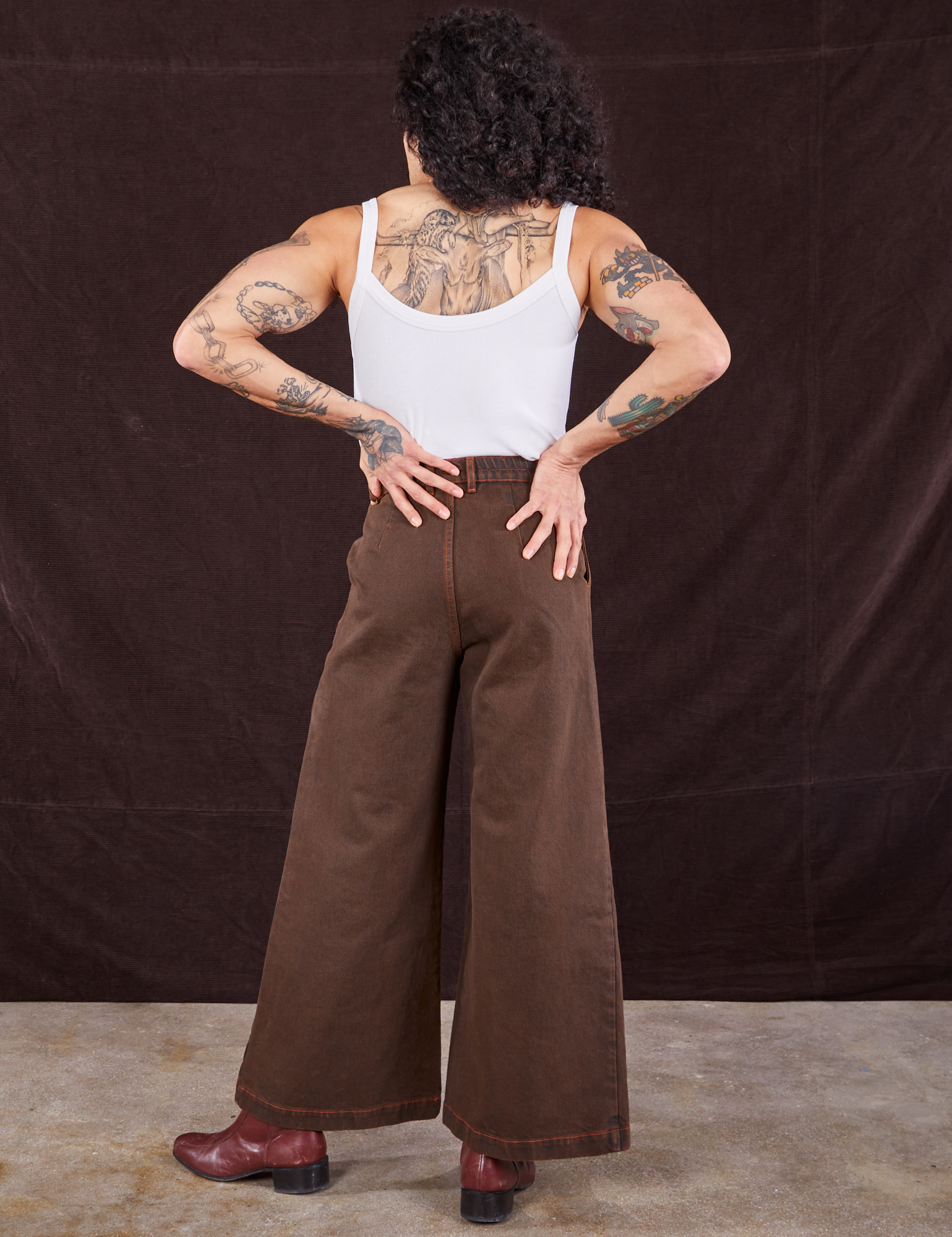 Back view of Overdyed Wide Leg Trousers in Brown and Cropped Cami in vintage tee off-white on Jesse