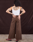 Back view of Overdyed Wide Leg Trousers in Brown and Cropped Cami in vintage tee off-white on Jesse