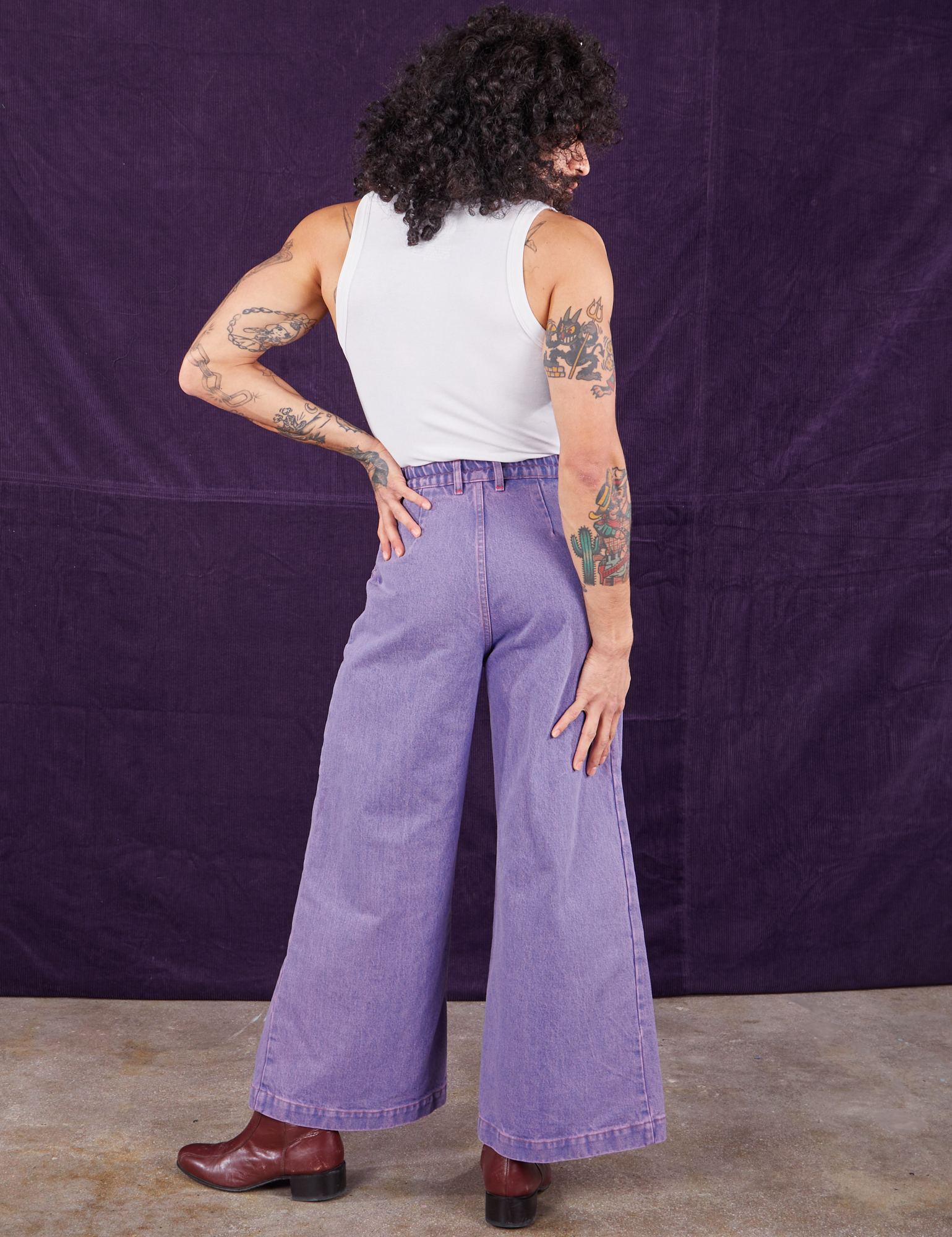 Back view of Overdyed Wide Leg Trousers in Faded Grape and Cropped Tank Top in vintage tee off-white on Jesse