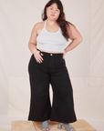 Ashley is 5'7" and wearing 1XL Petite Bell Bottoms in Basic Black paired with a Halter Top in vintage off-white