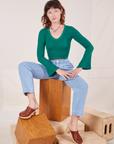 Alex is wearing Bell Sleeve Top in Hunter Green and light wash Trouser Jeans