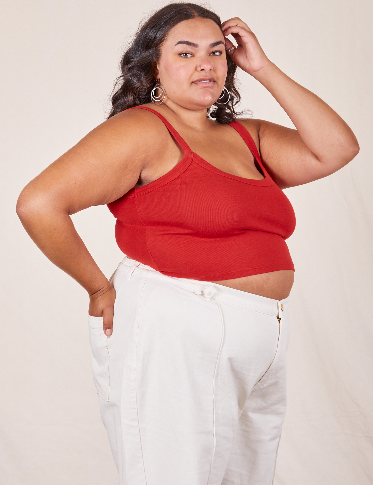 Angled side view of Cropped Cami in Mustang Red and vintage tee off-white Western Pants worn by Alicia