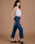 Side view of Carpenter Jeans in Dark Wash and Cropped Tank in Vintage Tee White on Alex