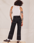 Back view of Carpenter Jeans in Black and Tank Top in vintage tee off-white worn by Jesse