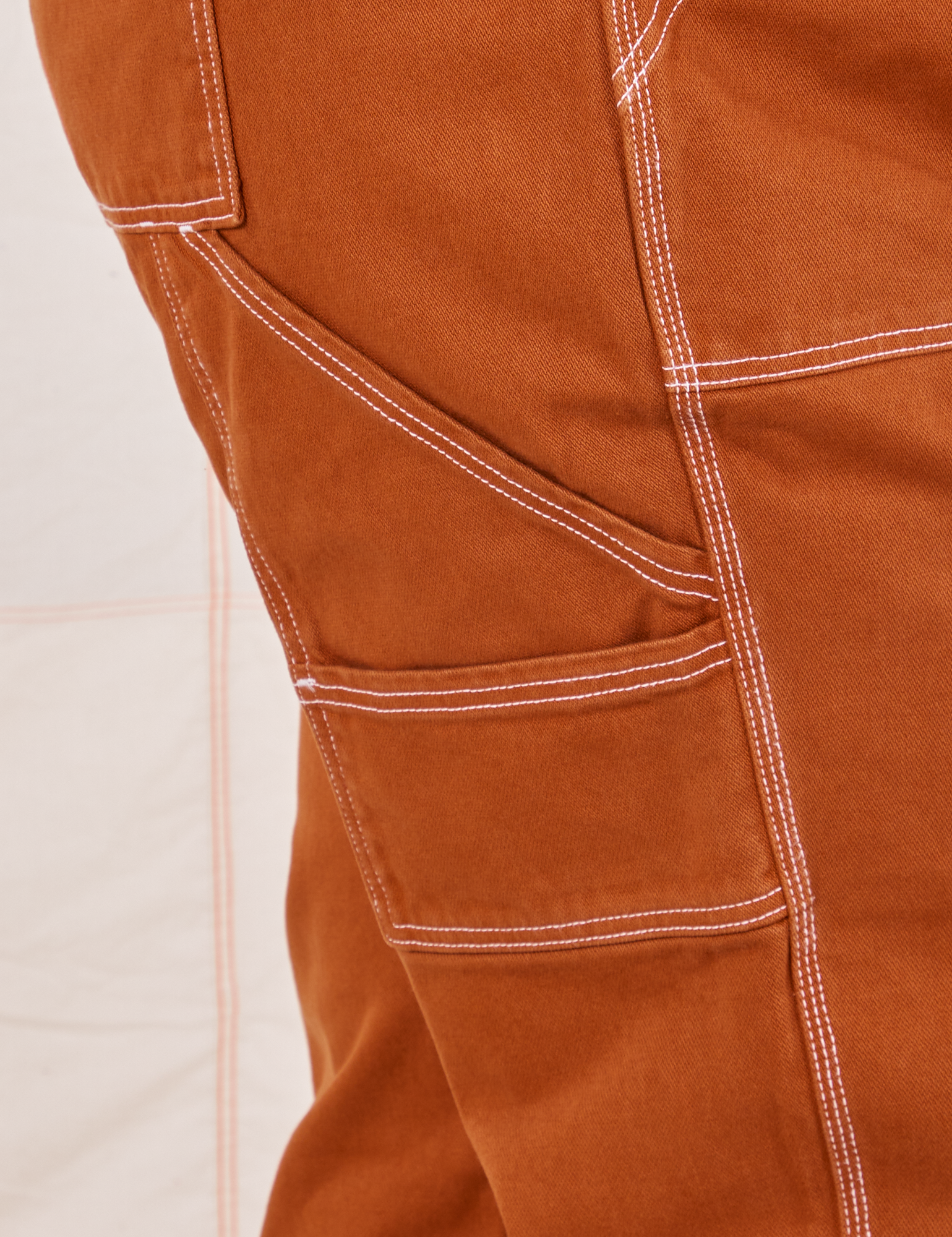 Carpenter Jeans in Burnt Terracotta close up of contrast white topstitching