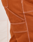 Carpenter Jeans in Burnt Terracotta close up of contrast white topstitching