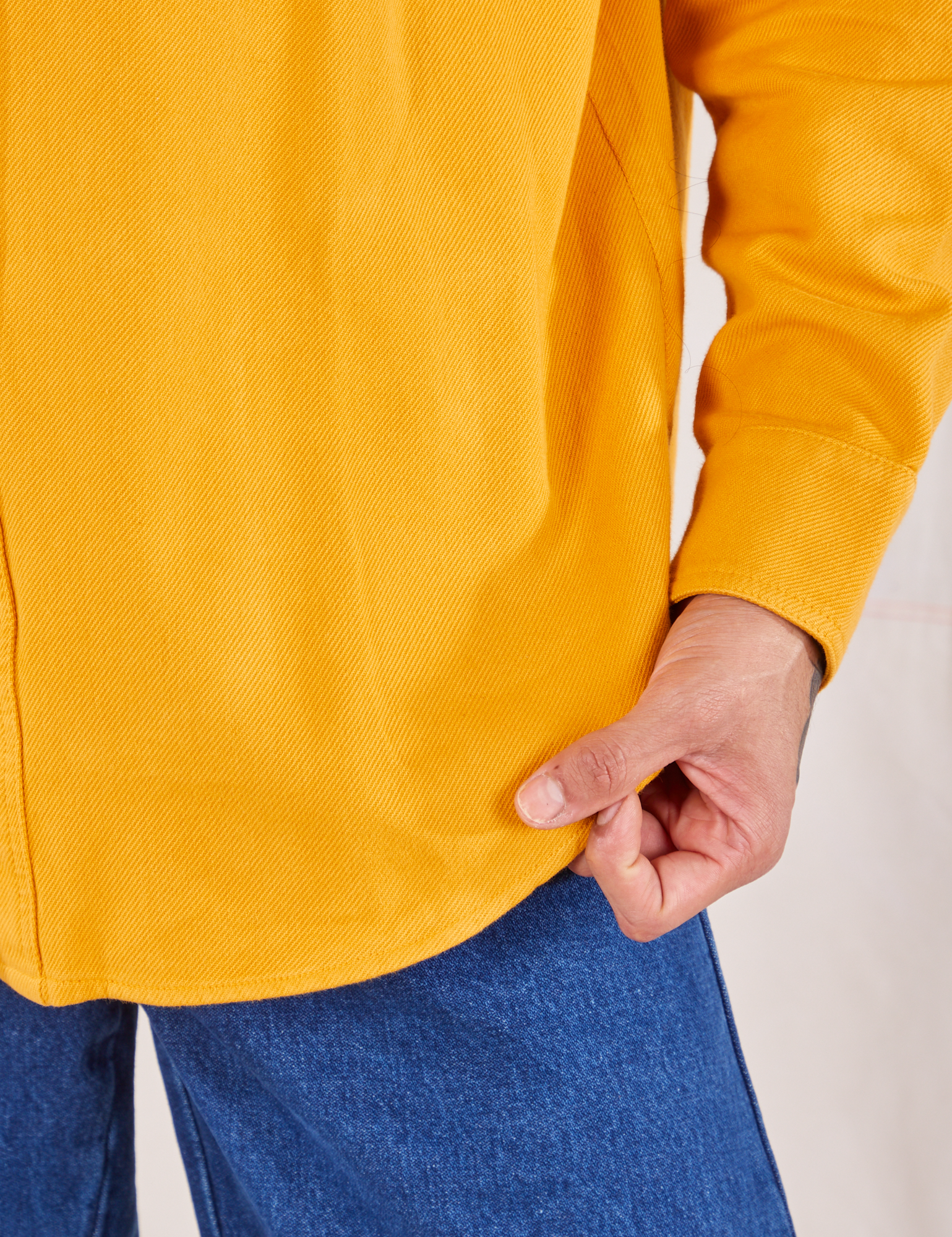 Flannel Overshirt in Mustard Yellow bottom hem close up on Jesse
